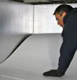 contractor installing TerraBlock™ floor insulation in a Olathe crawl space