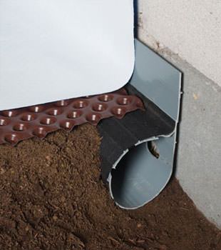 Closeup of a crawl space drainage system installed in Parlin